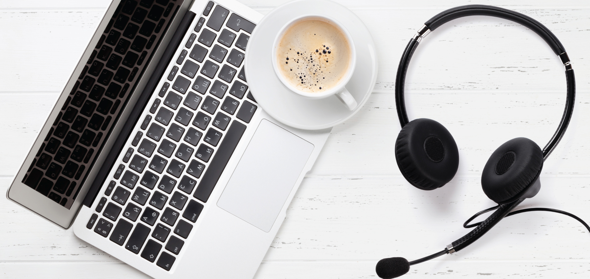 image of a laptop, coffee, and headphones